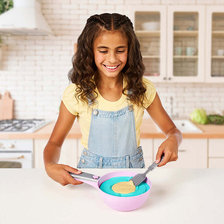 Child playing with Cookeez Makery Pancake Treatz Playset in kitchen