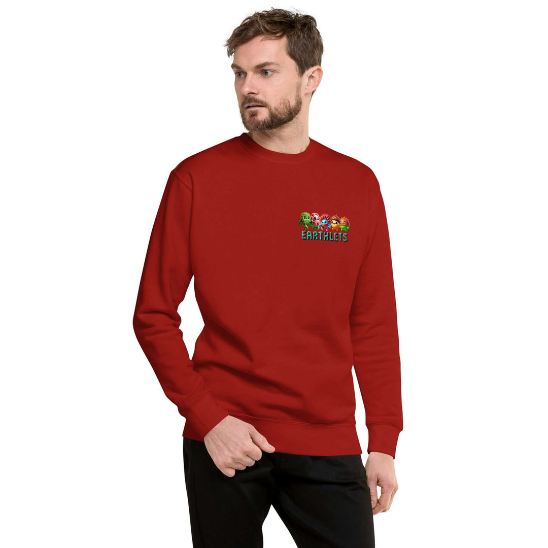 Man wearing a red Earthlets unisex premium sweatshirt with a colorful logo on the chest.