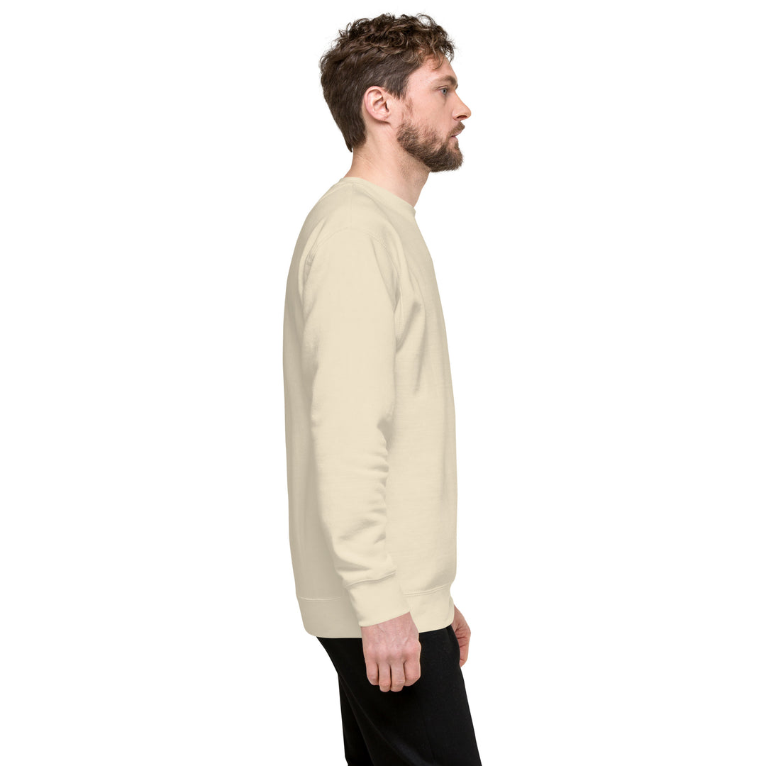 Side view of a man wearing an Earthlets unisex premium sweatshirt in beige, showcasing its classic silhouette.