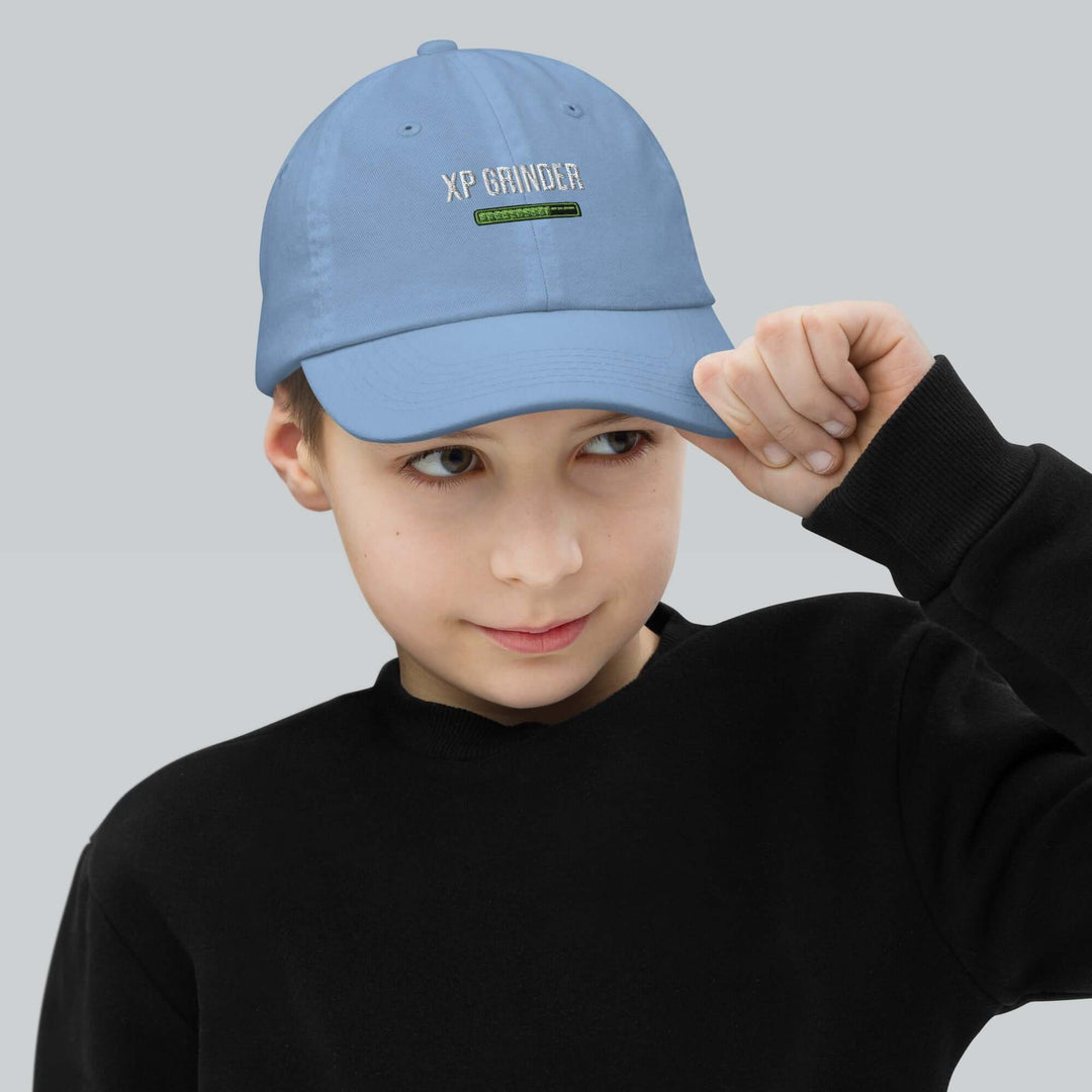 XP Grinder Youth baseball cap on a young boy, showcasing the stylish design and comfort for outdoor activities.