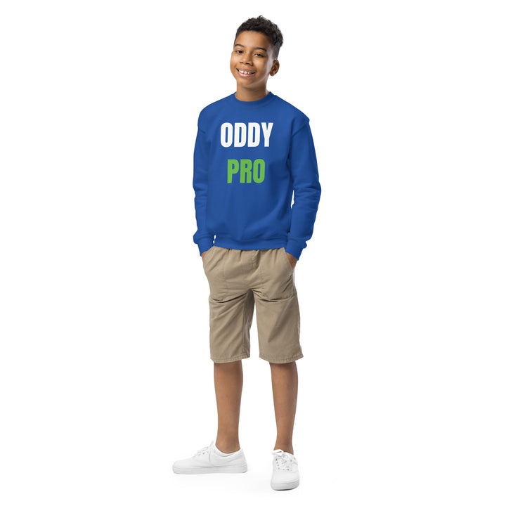 Oddy Pro Youth crewneck sweatshirt on a smiling boy wearing shorts and white sneakers, showcasing a comfortable style.