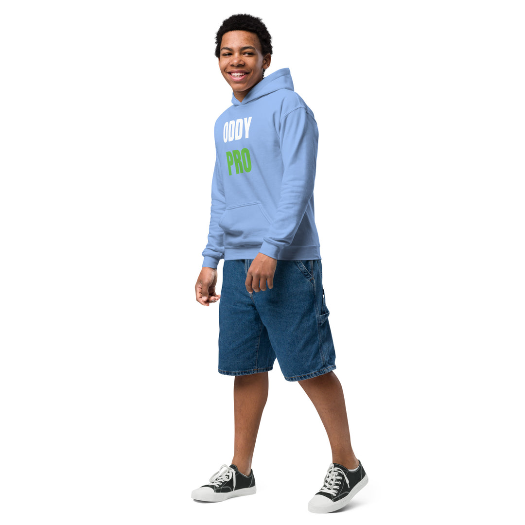 Oddy Pro Youth heavy blend hoodie worn by a smiling boy in a light blue color with denim shorts.