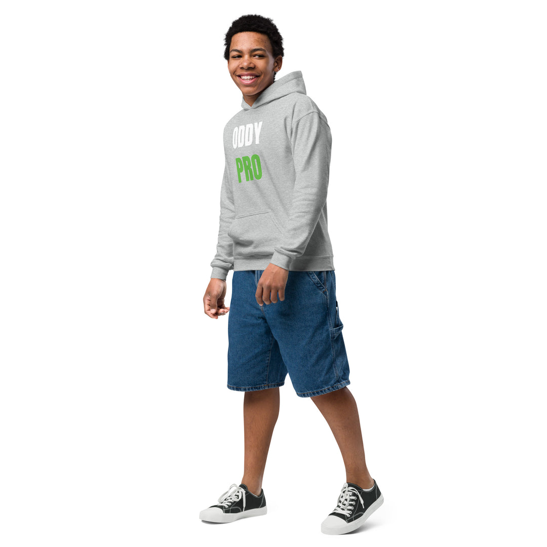 Boy wearing Oddy Pro Youth heavy blend hoodie with shorts and sneakers, smiling and standing casually.